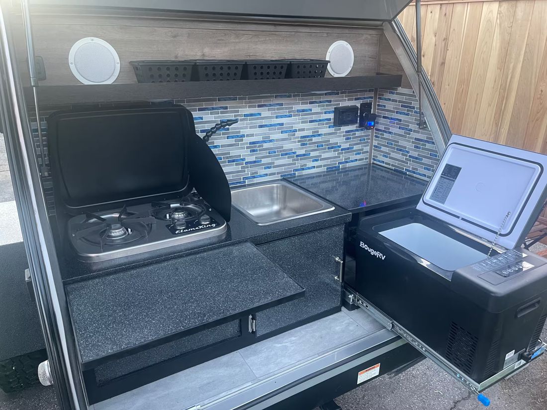 Outdoor kitchen with stove and sink