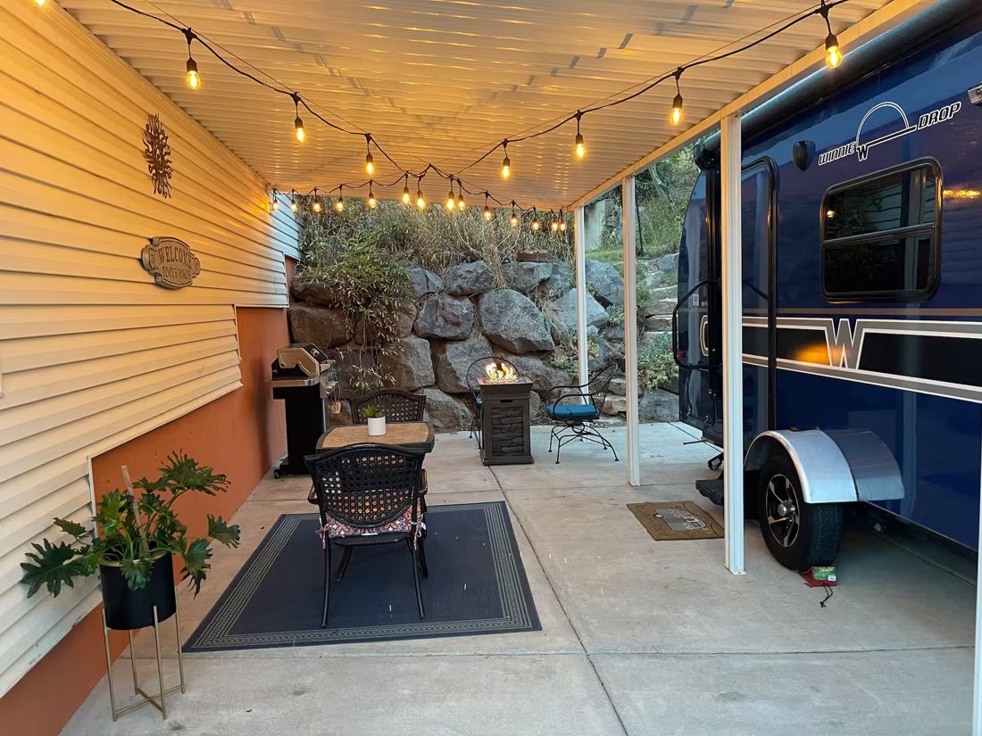 Covered patio with string lights and fire pit
